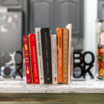 A set of cookbooks neatly arranged between bookends on a marble countertop, offering culinary inspiration in a vacation rental's kitchen in St. Augustine.