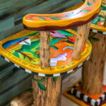 Close-up of hand-painted bar stools featuring vibrant colors and inspirational quotes, part of the artistic decor in a St. Augustine vacation rental.